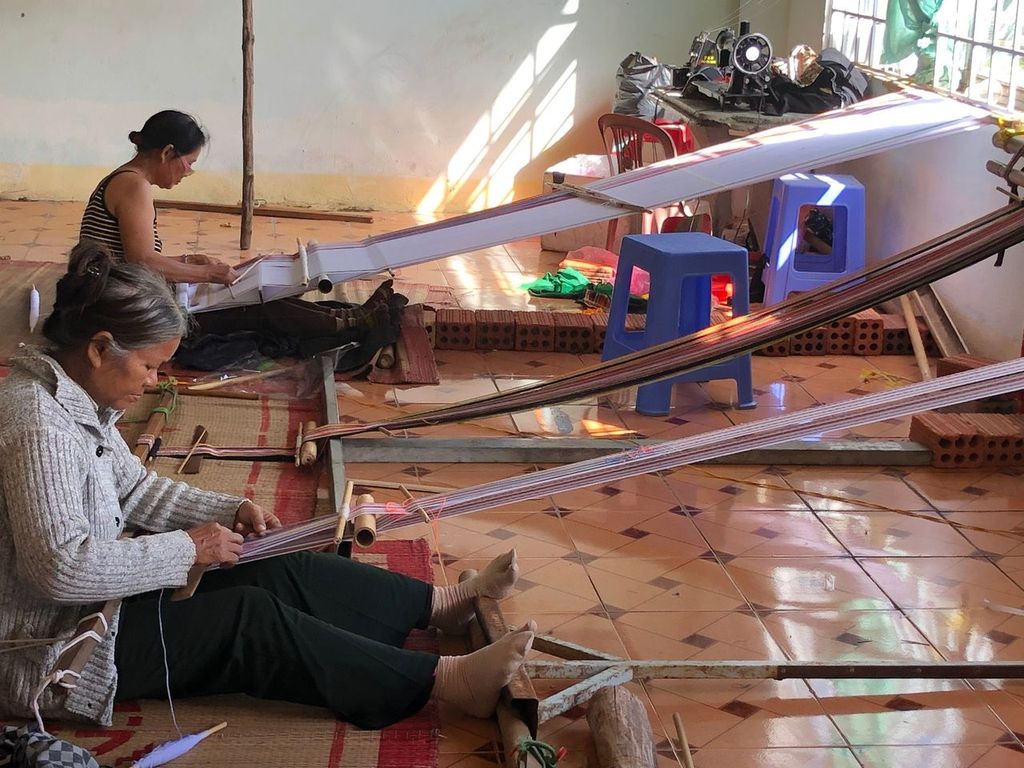 Weavers making traditional Bahnar clothes near the Kon Klor Communal House in Kon Tum, Vietnam