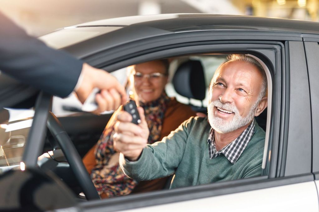 Happy senior couple buying a car