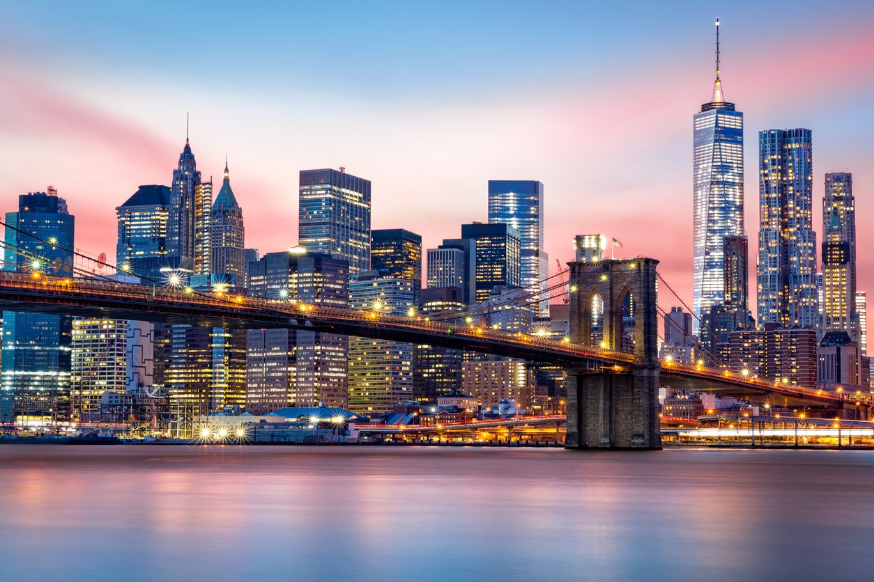 Brooklyn Bridge at and the Lower Manhattan skyline during sunset.