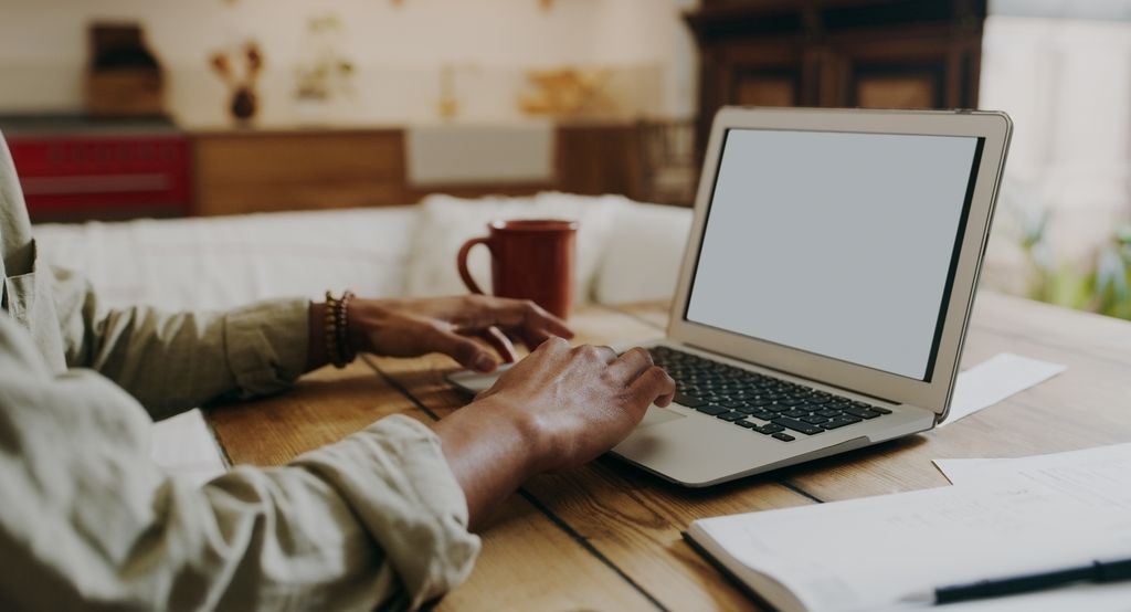 man sitting alone at home and using his laptop