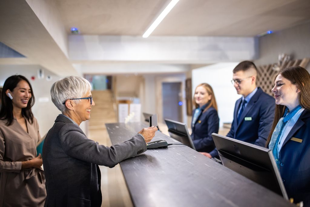 Businesswoman and her assistant checking into a hotel at the reception