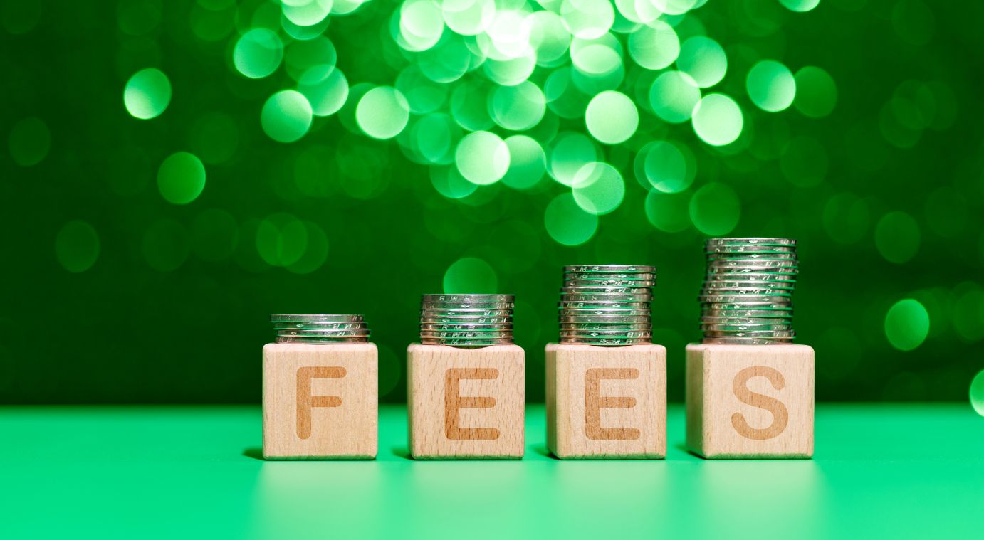 Stack of coins on word fees