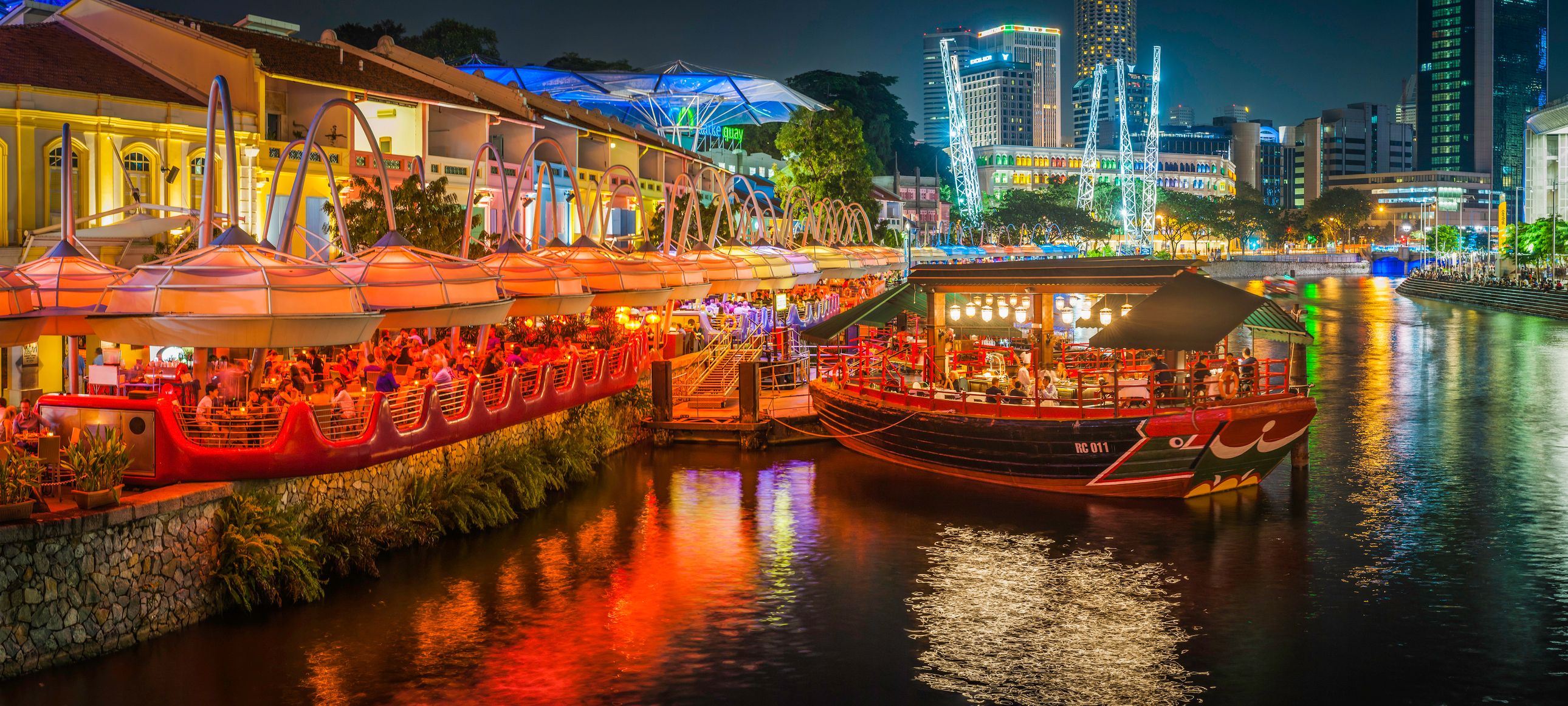 Singapore crowds at restaurants bars Clarke Quay illuminated at night