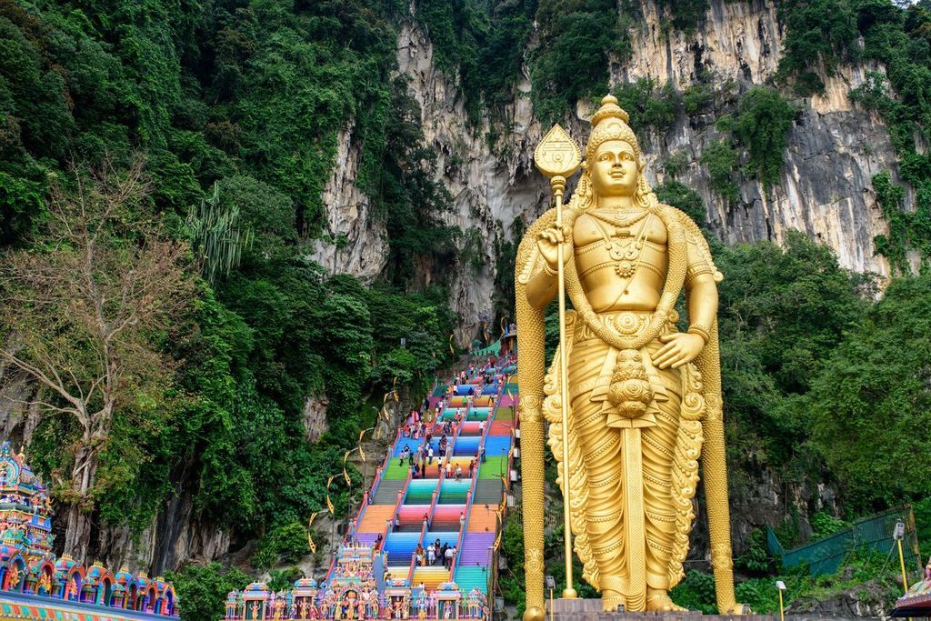 Batu Caves  with Lord Murugan standing tall at the base in Kuala Lumpur, Malaysia