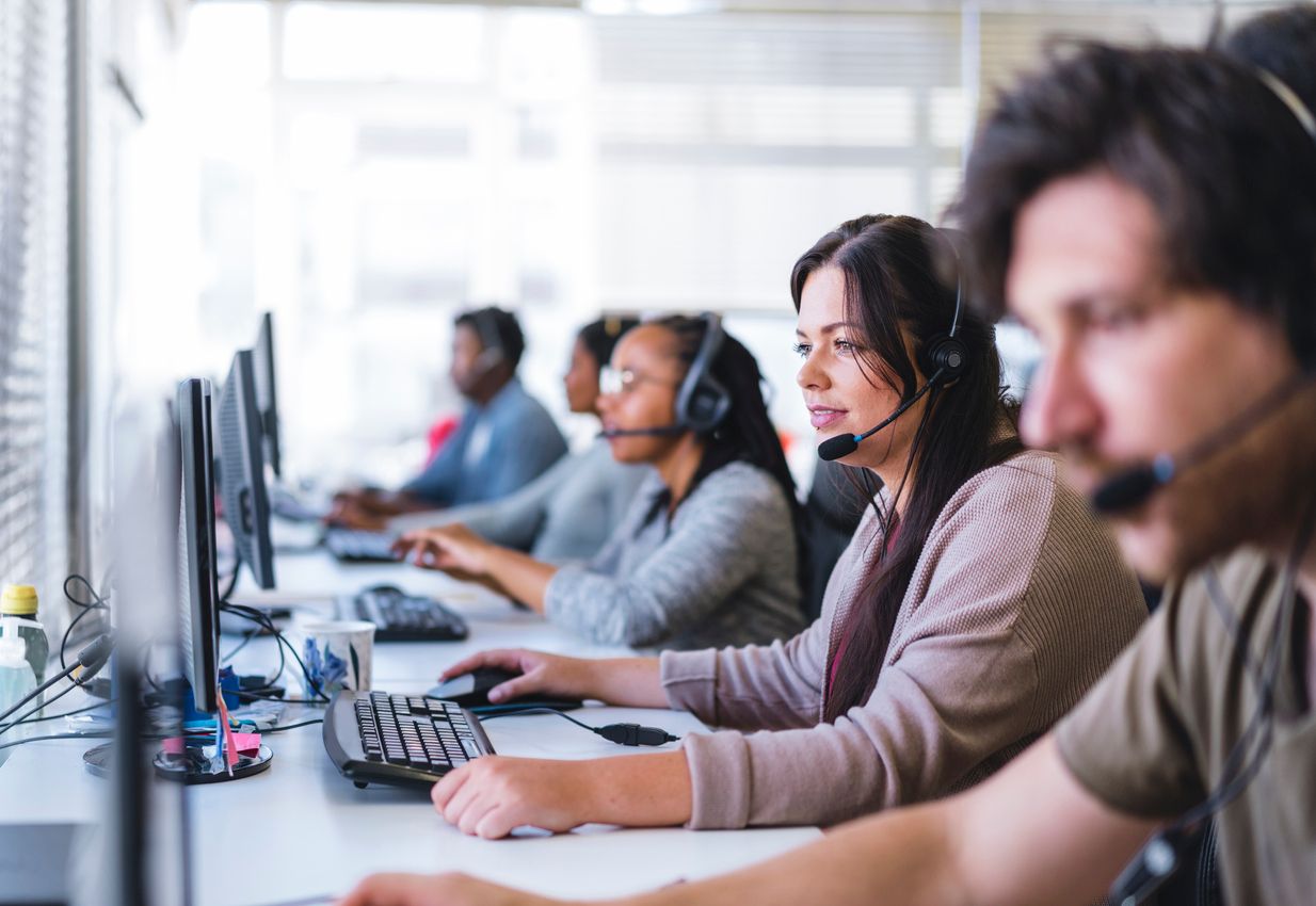 Businesswoman wearing headset while using computer