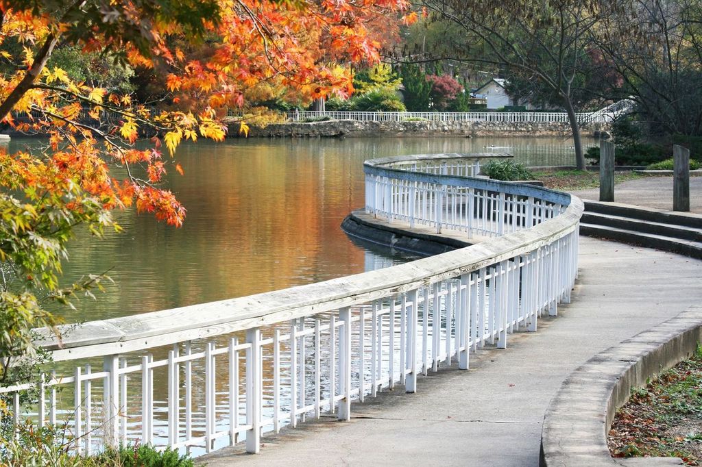 Winding walk path beside pond of Pullen park, Raleigh, North Carolina