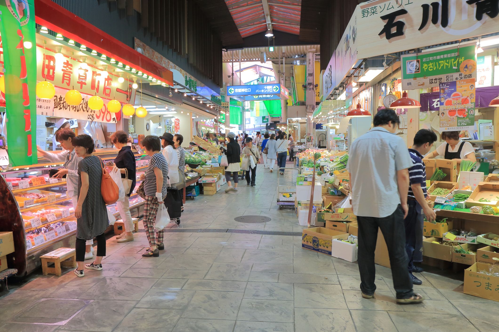 Tourists and local people shop at famous Omicho market in Kanazawa Japan.