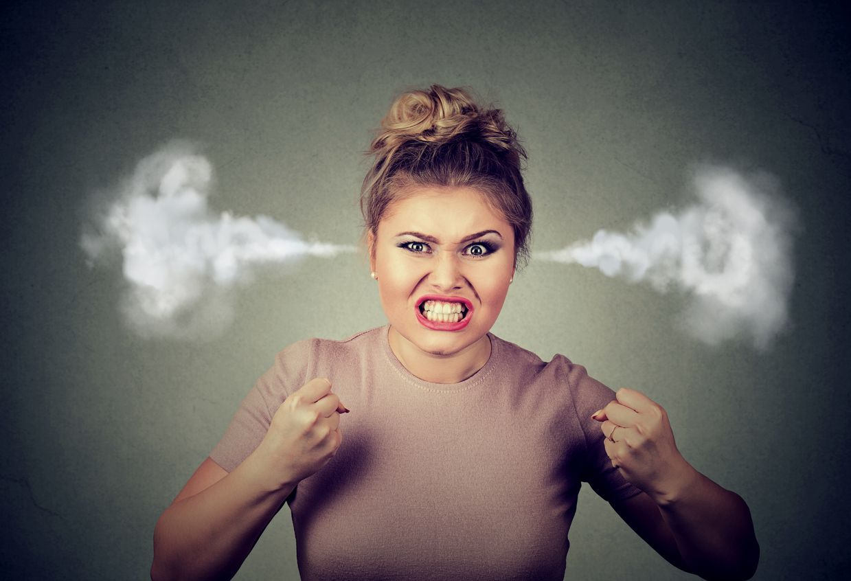 Angry woman blowing steam coming out of ears