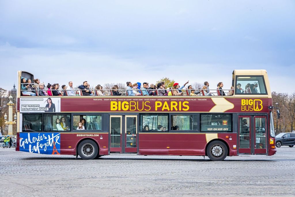 Big Bus driving in a street of Paris