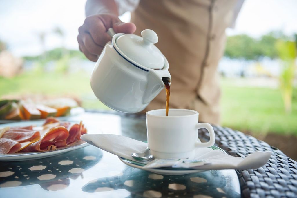 Waiter pouring coffee