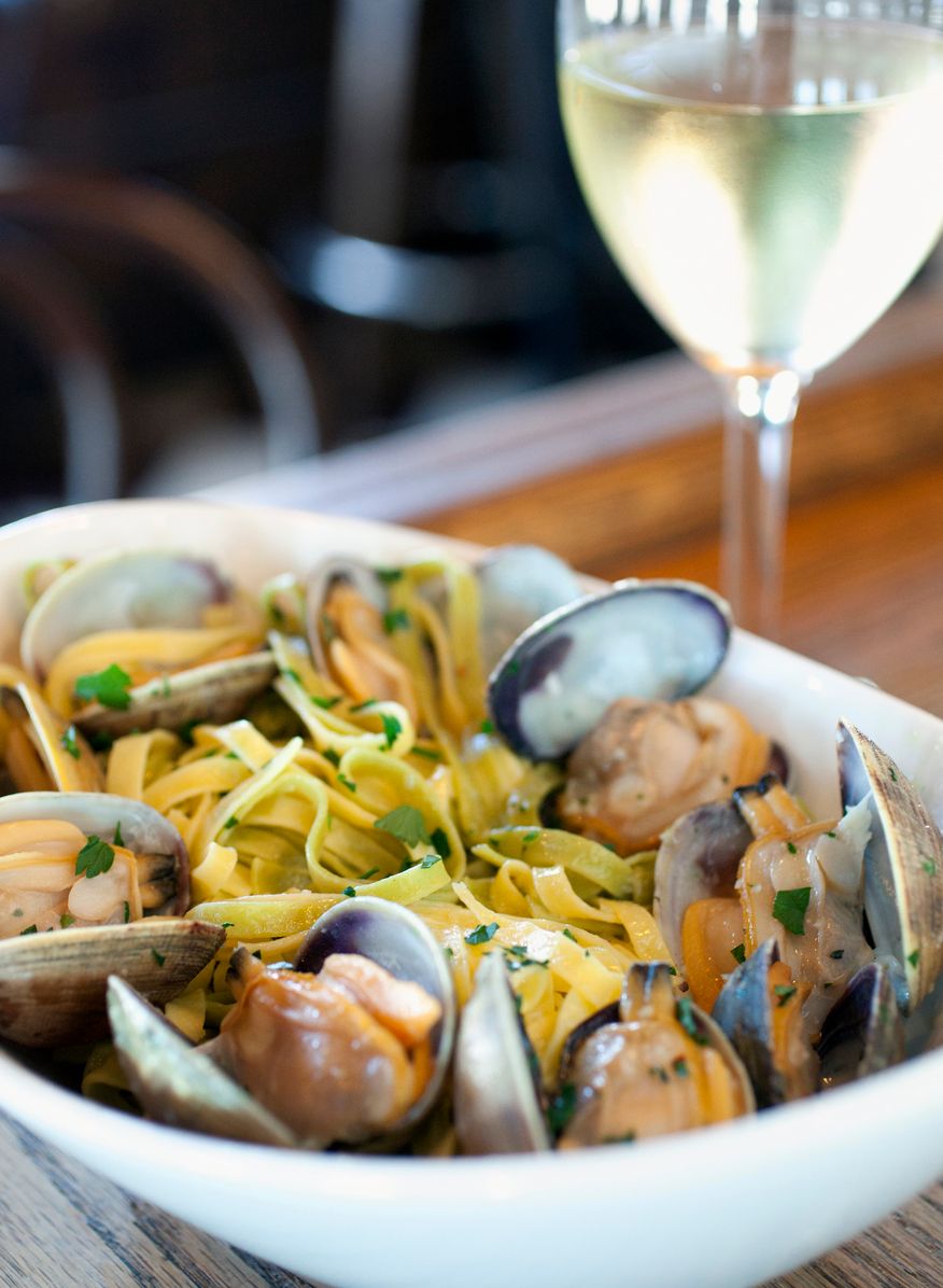 linguine with clams served with a glass of wine