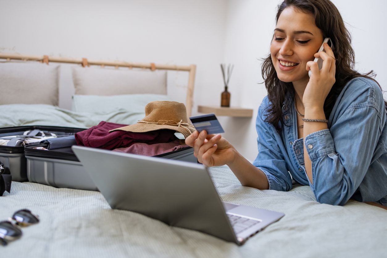 Woman using laptop to book travel reservation.