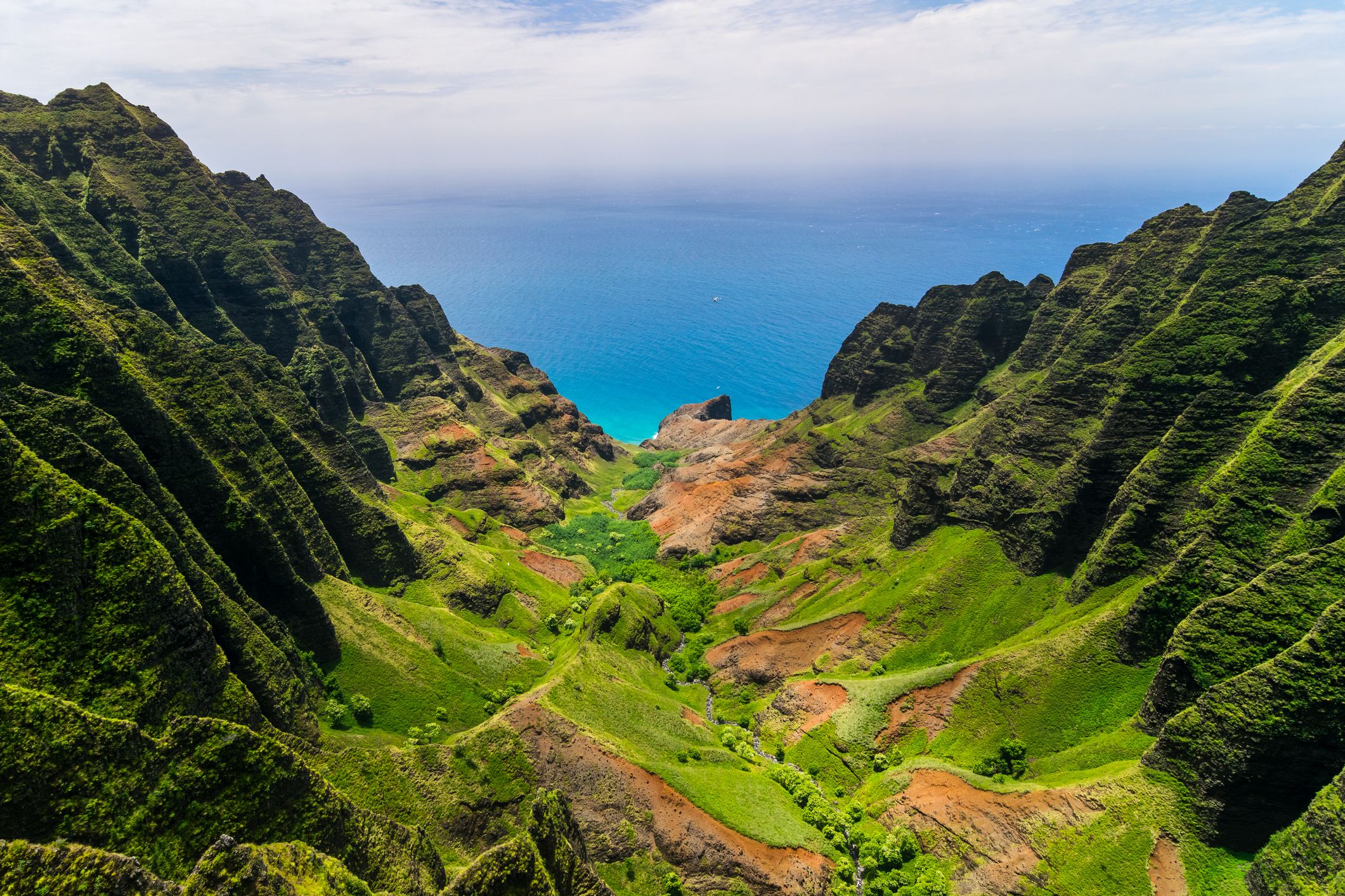 Aerial landscape view of cliffs and green valley, Kauai