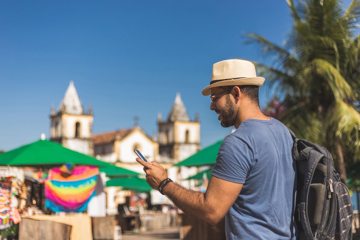 Tourist using phone for booking trip.