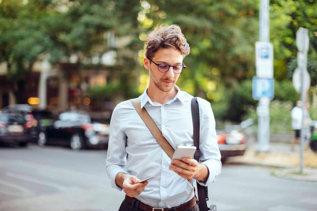 Man booking vacation on his phone