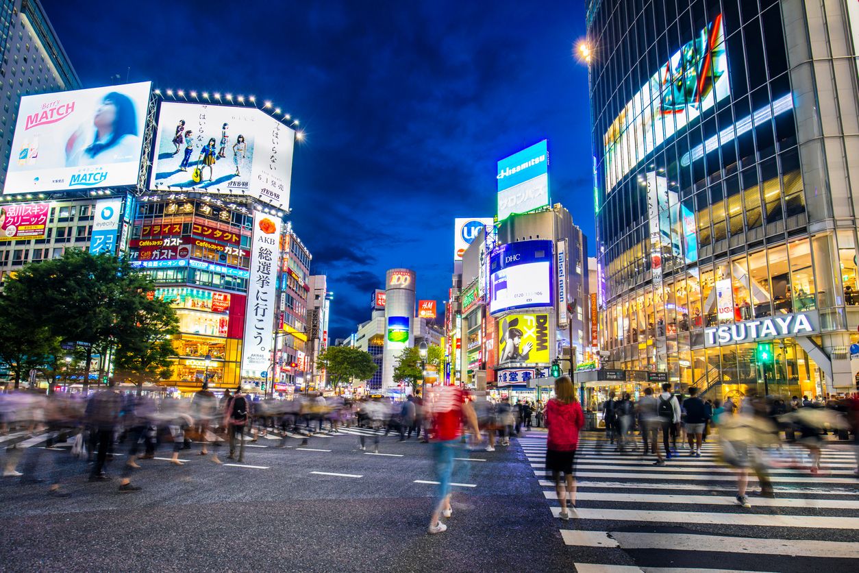 People walking in Shibuya crossing at dusk