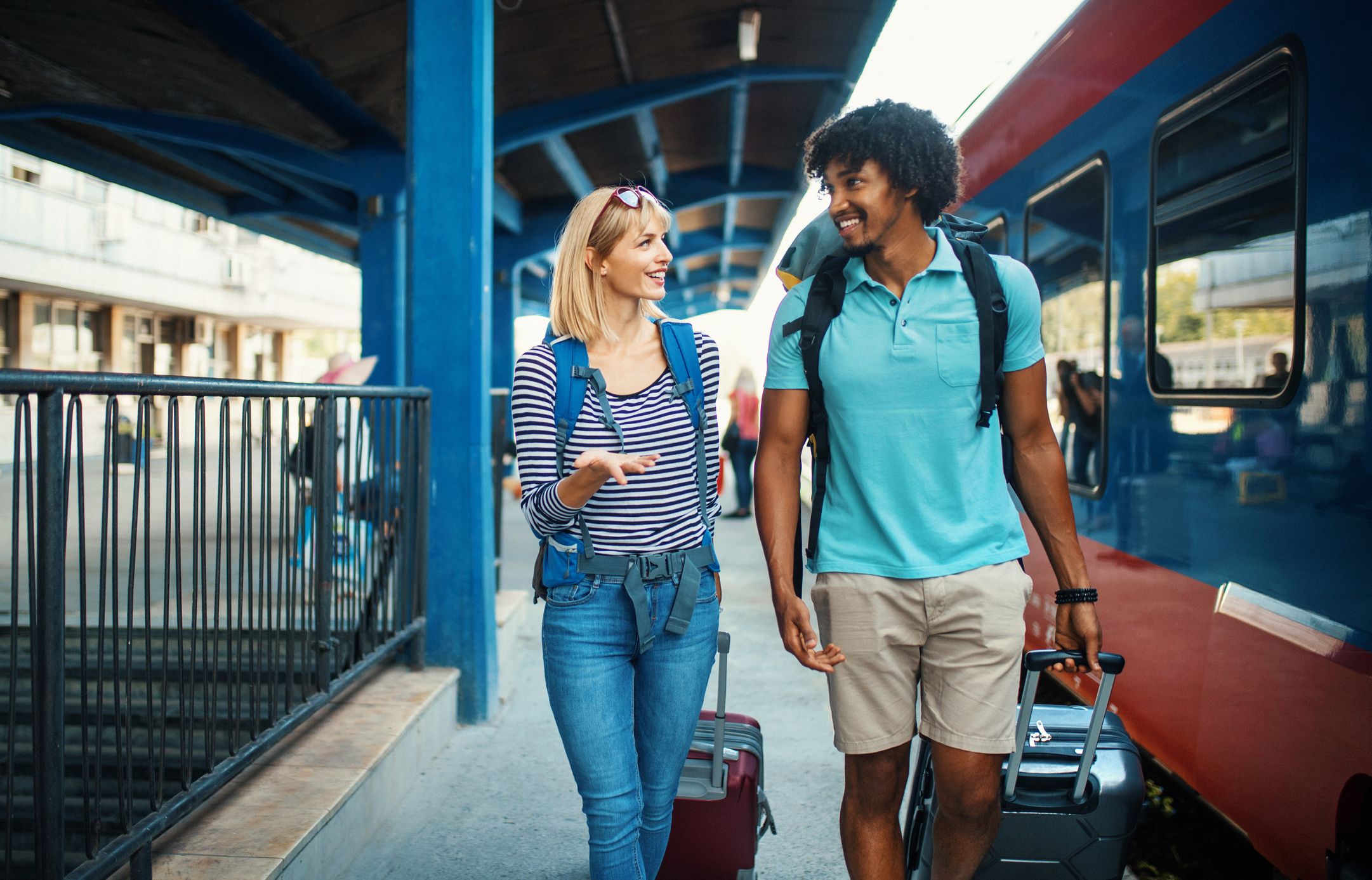 Young couple at train station leaving for a weekend trip