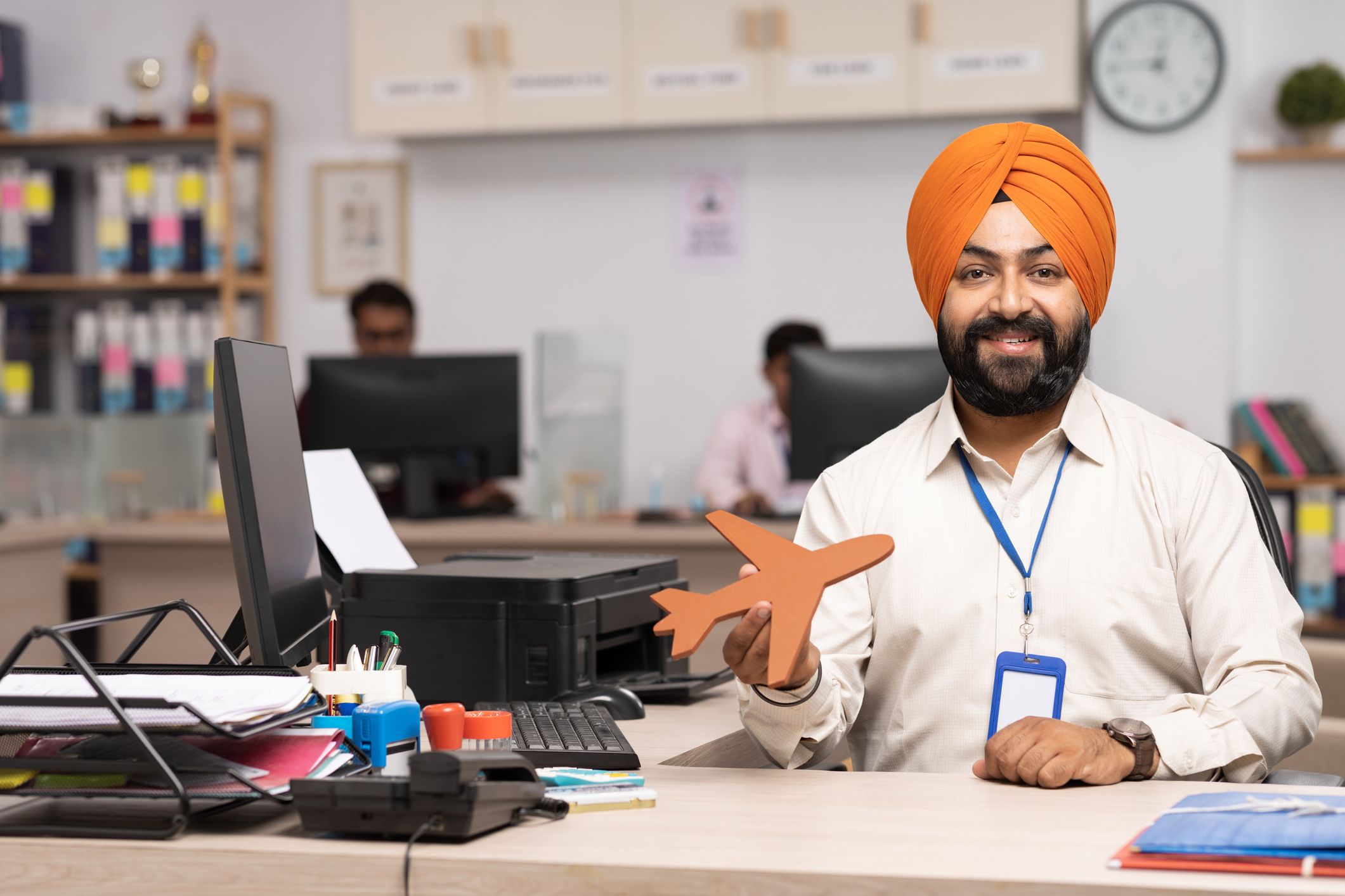 Indian Sikh travel agent working in office