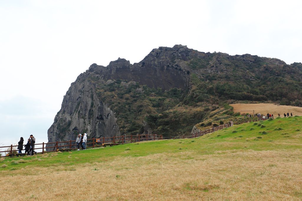 People sightseeing on Seongsan Ilchulbong, also known as, Sunrise Peak.
