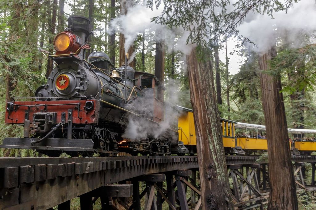 Roaring Camp' Dixiana Shay Steam Train over Trestle Crossing Redwoods in Felton, California