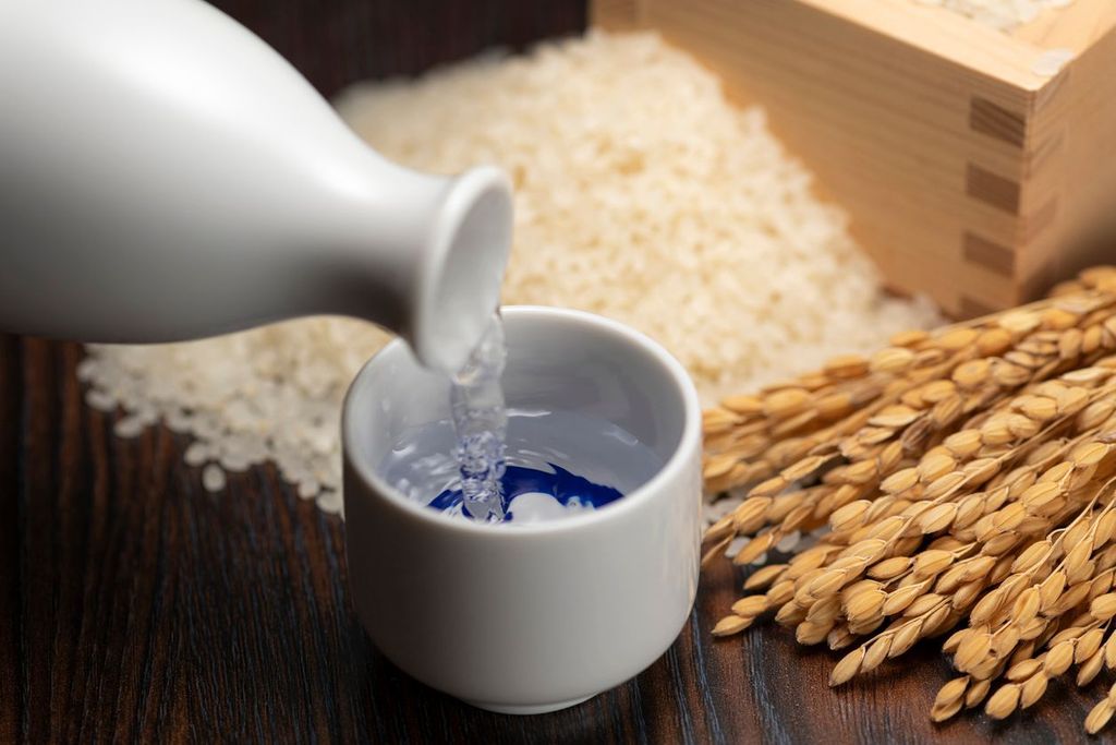 Cold sake with rice and ear of rice on the table