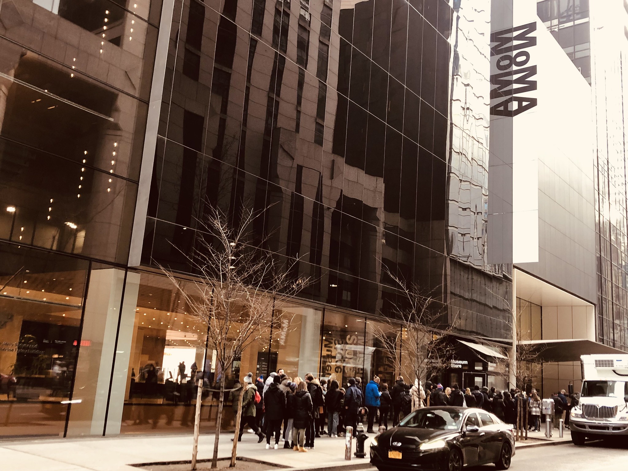 Entrance with a line up outside the Museum of Modern Art (MoMA) - New York City.