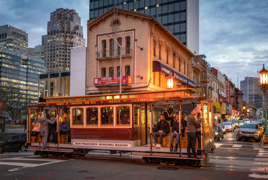 Passengers riding a traditional cable car in San Francisco