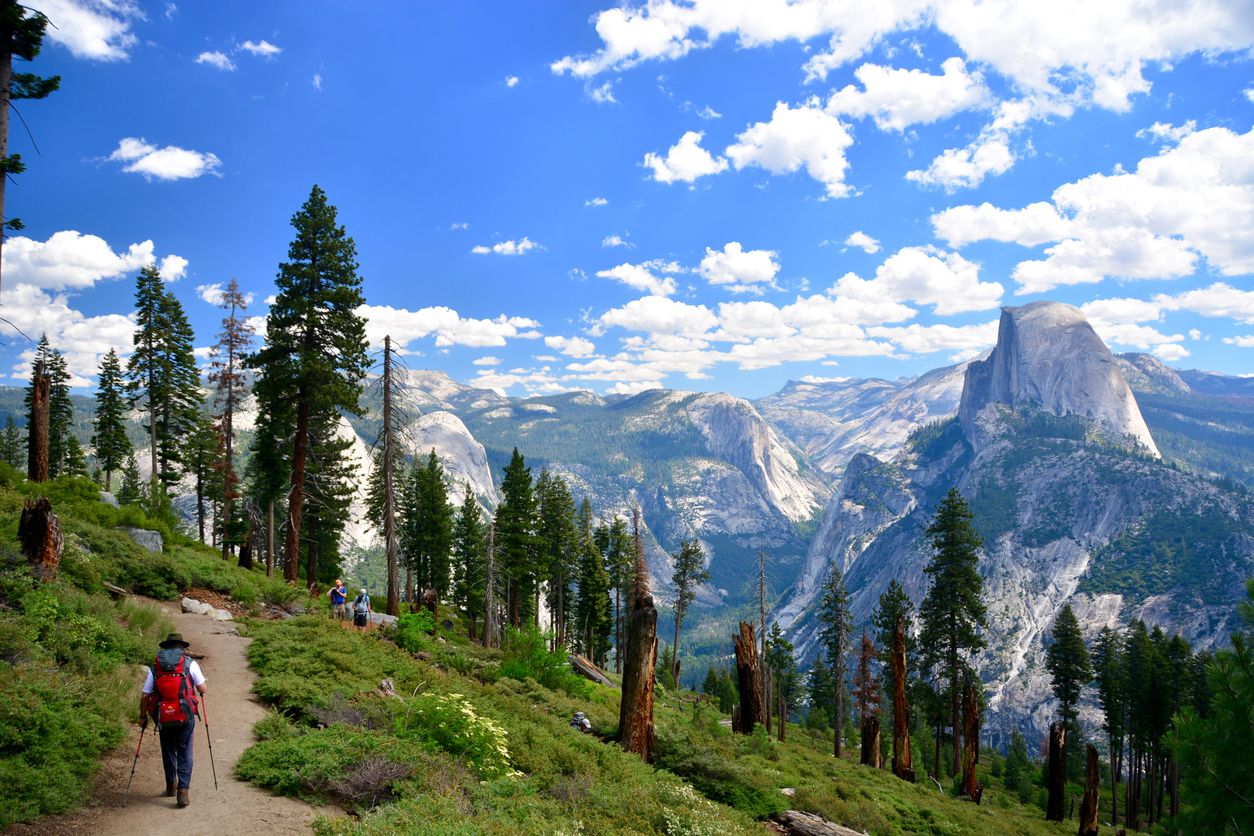 People hikers hiking in Yosemite National Park on sunny day