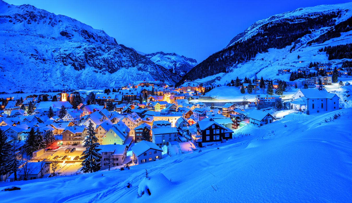 Andermatt village in Alps mountains in winter snow, Switzerland