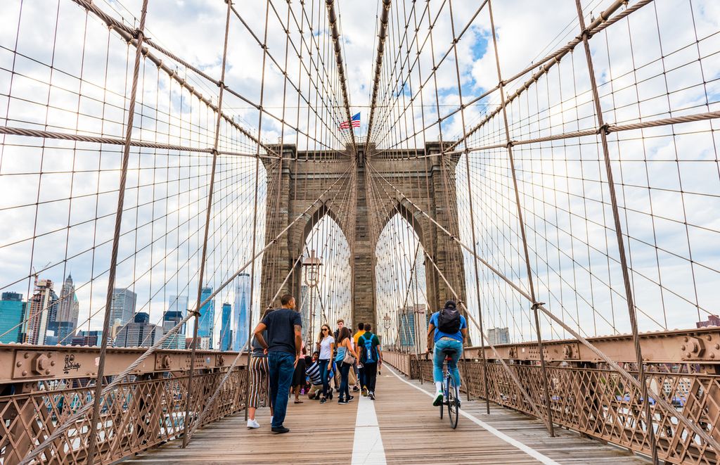 Tourists walking on the Brooklyn Bridge