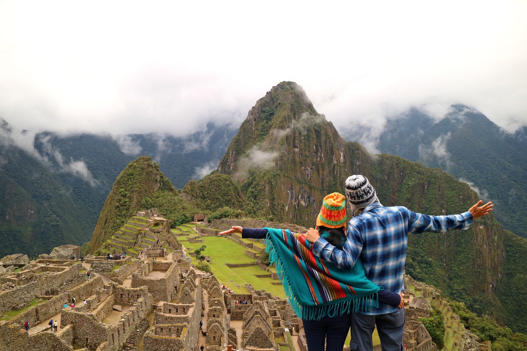 Couple admiring the spectacular view of Machu Picchu, Peru