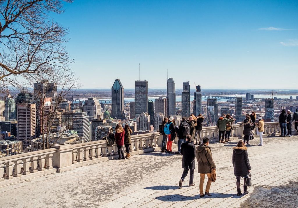 People on a terrace on Mont Royal, overlooking Montreal's downtown cityscape