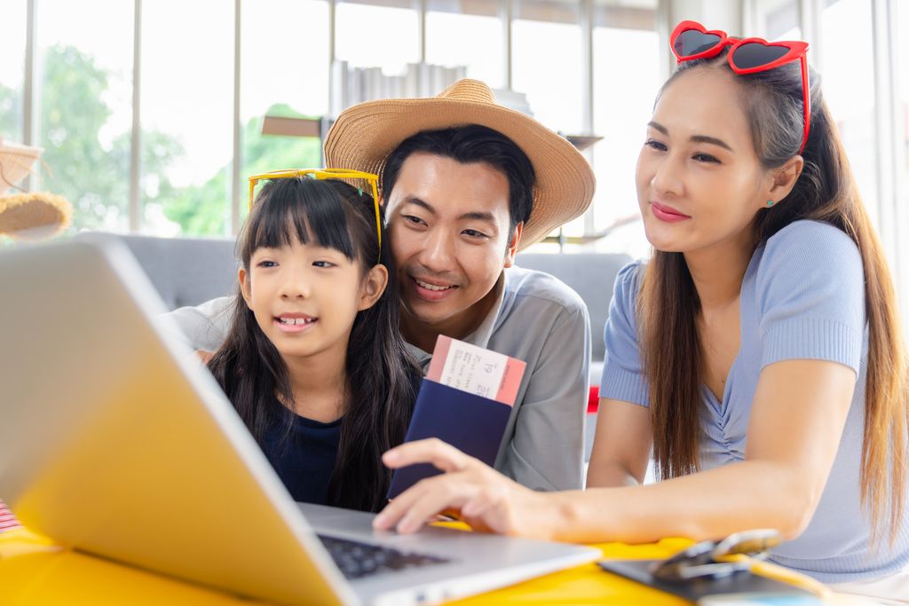 Young family booking ticket and hotel for vacation holiday travel trip