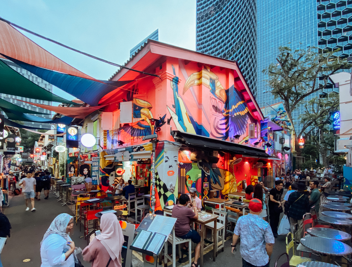 In the middle east inspired Haji Lane pub and shopping street in Singapore people rest and drink beers at the many bars or just walk along the street and do window shopping.