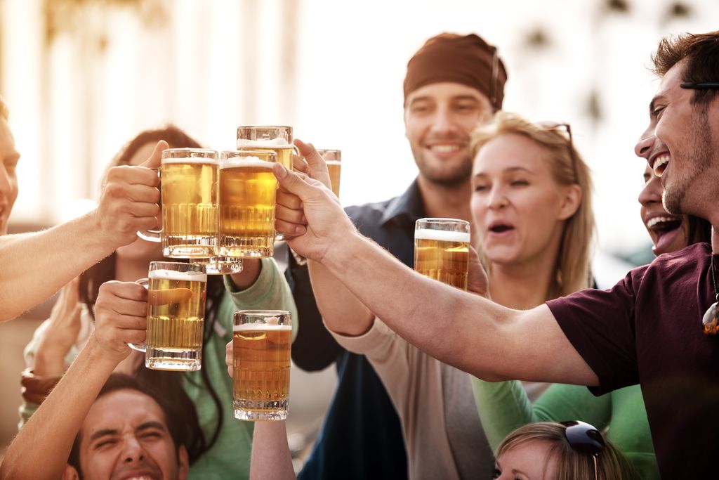 Young people at bistro having beer