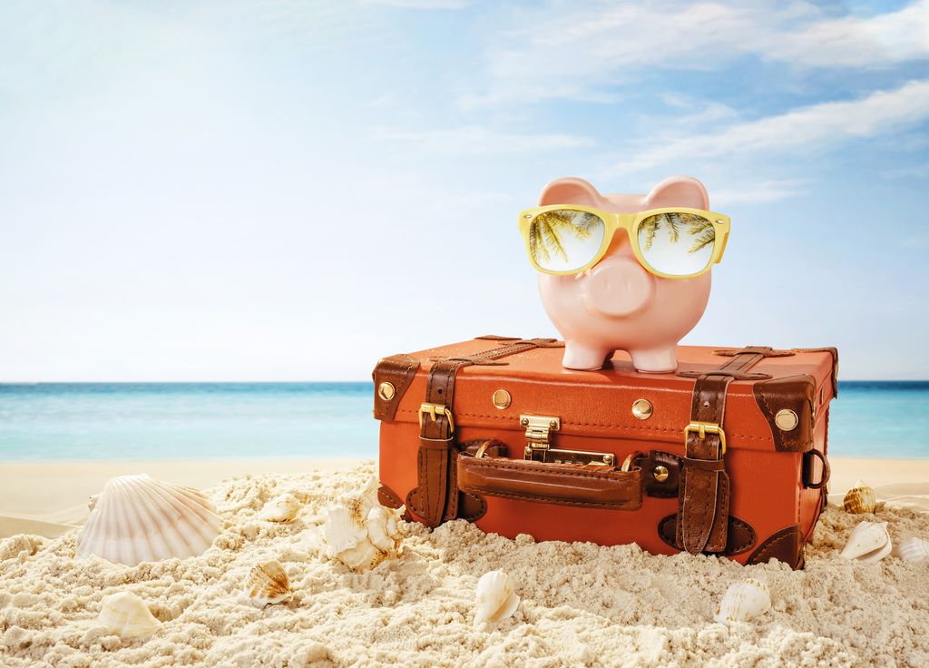 Piggy bank resting on the tropical beach.