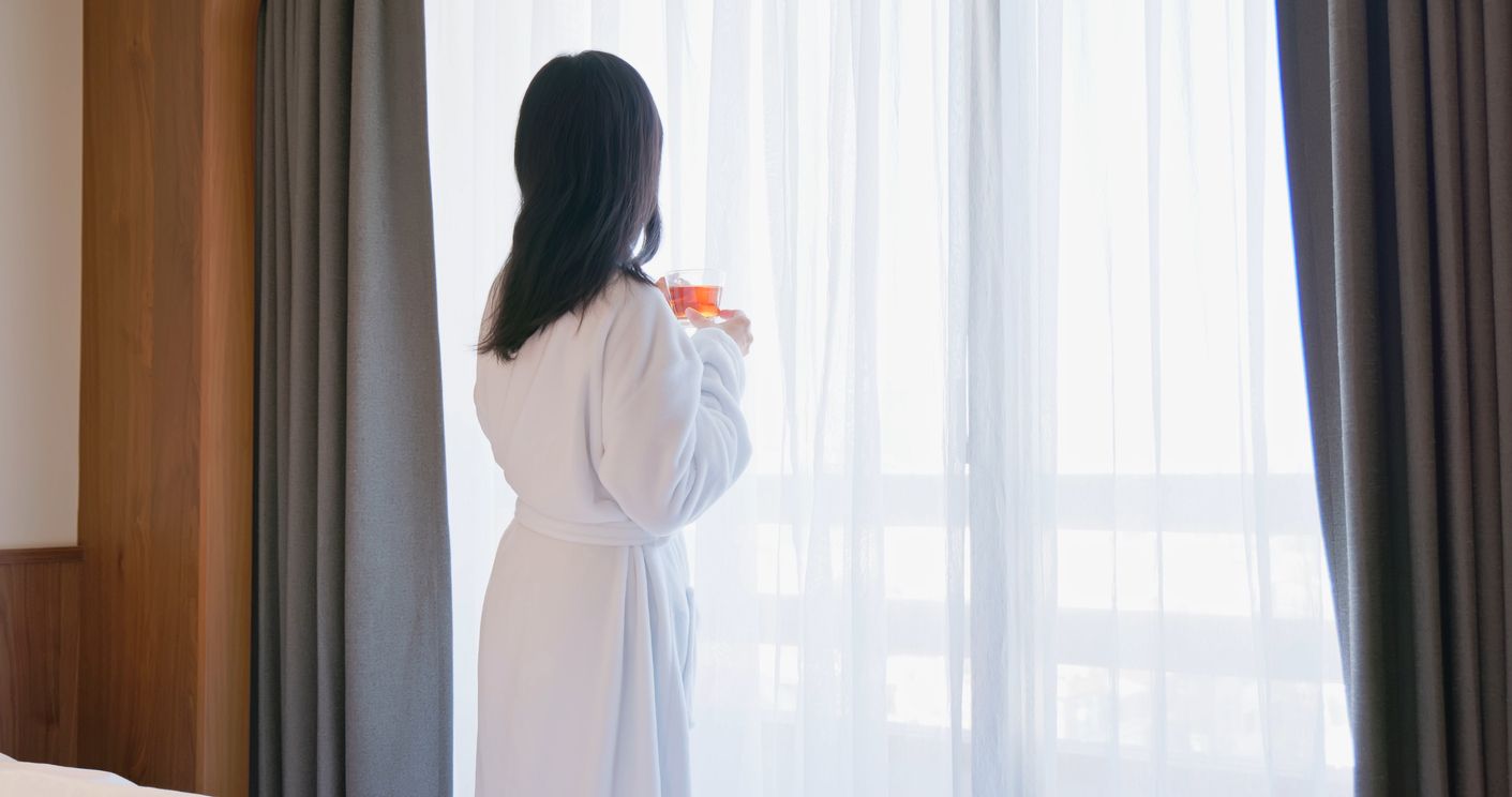 Woman by hotel window