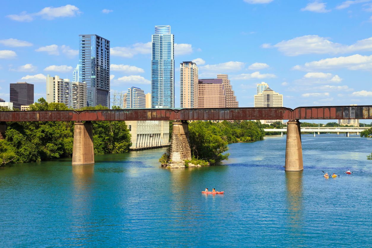 Austin Texas Skyline with people kayaking on Lady Bird Lake