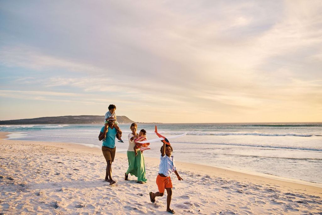 Young family walking on the beach together