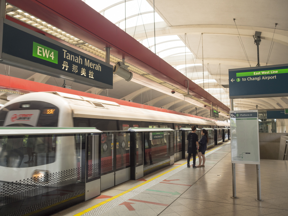 Commuters are waiting at the platform areas, for the train to arrive into the Tanah Merah Station.