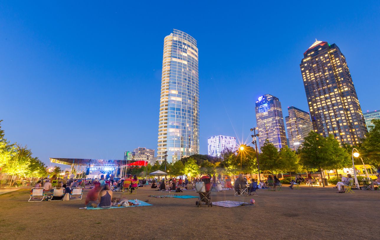 People are relaxing and picnicking in free music in the park event in Klyde Warren Park, uptown Dallas, TX.