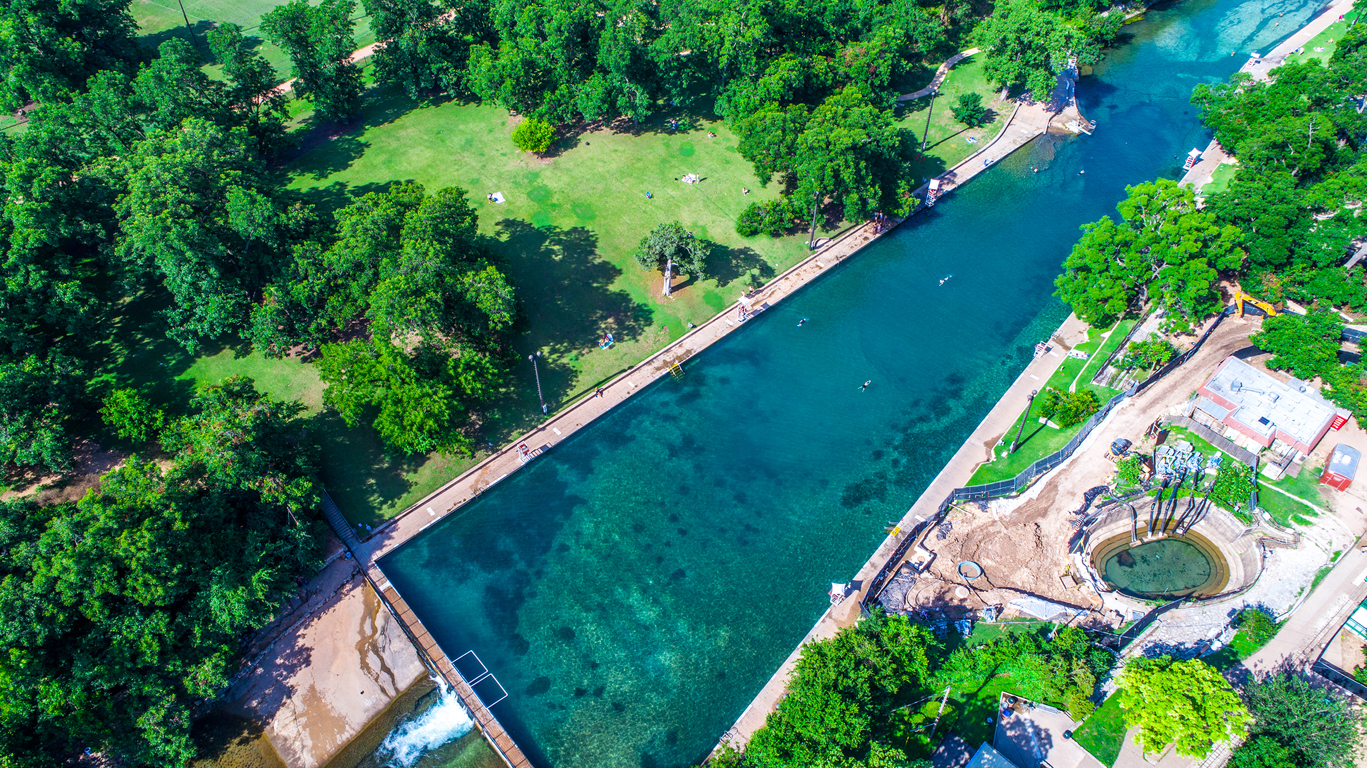 Barton Springs Natural Swimming Pool is one of the Best in the World aerial drone view of Summer Swimming hole in Austin , Texas