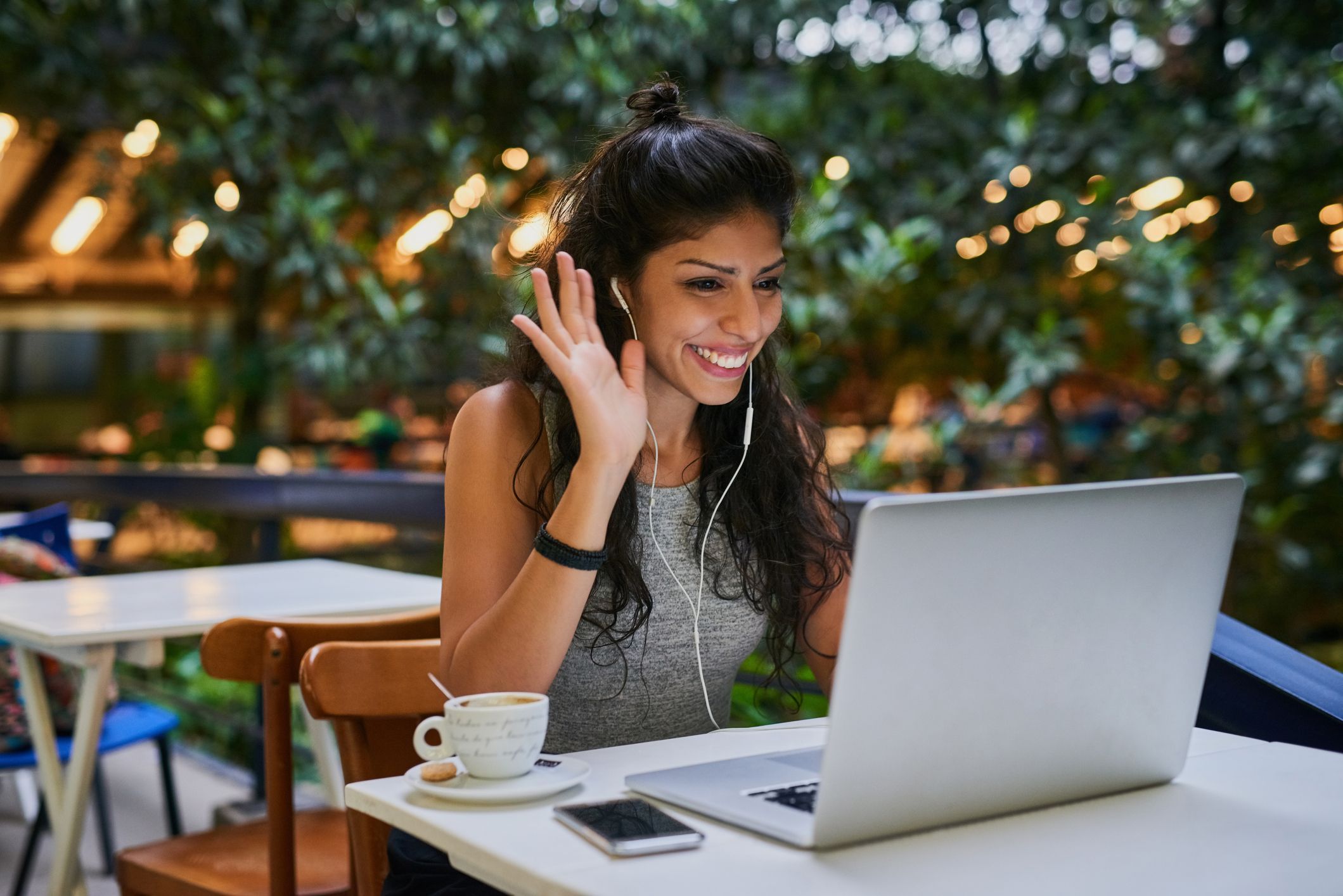 Young woman making a video call at a cafe