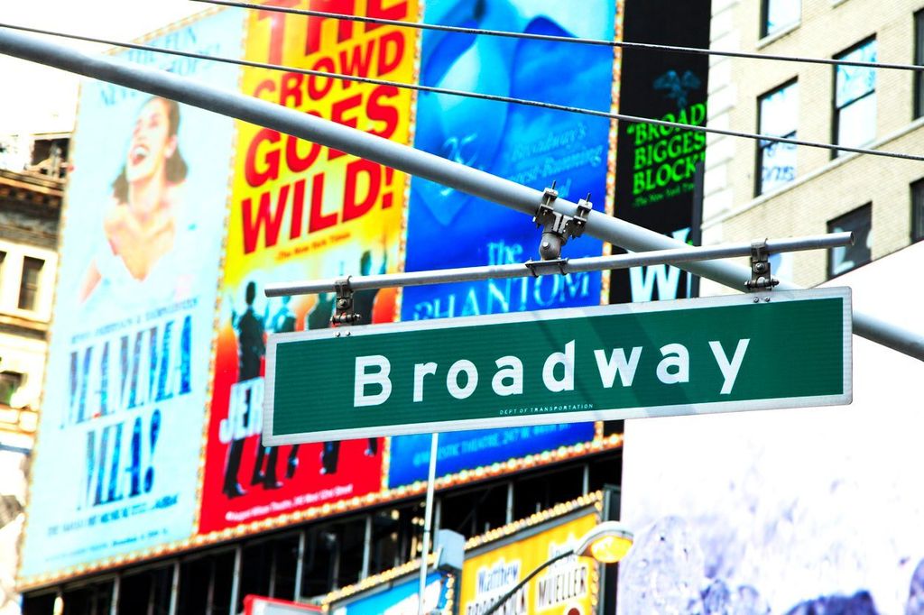 Broadway street sign with Broadway musical billboard Times Square in New York