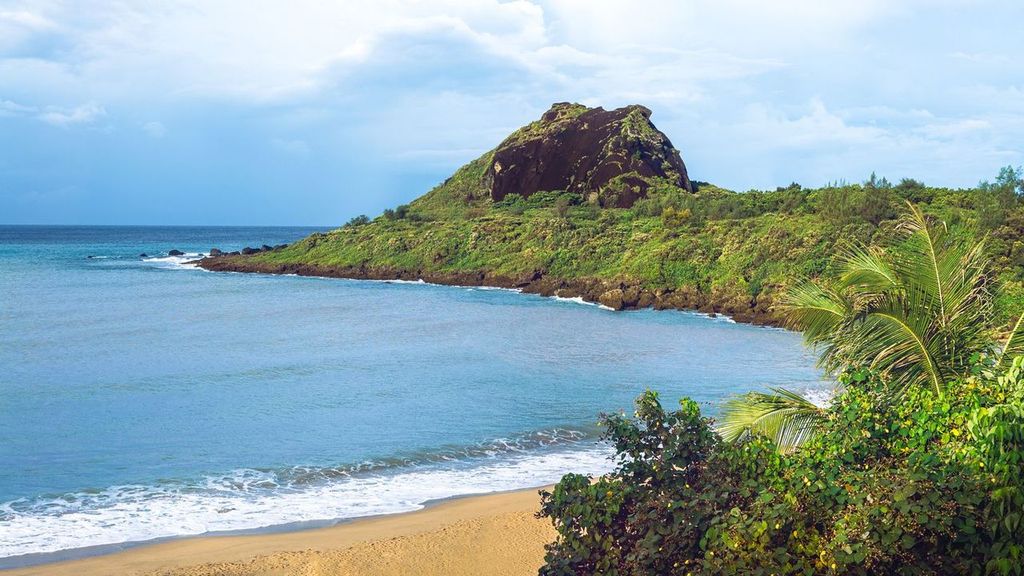 Beach on the Island of Taiwan. Idyllic tropical paradise with its tall lush mountains, sea and white sand.