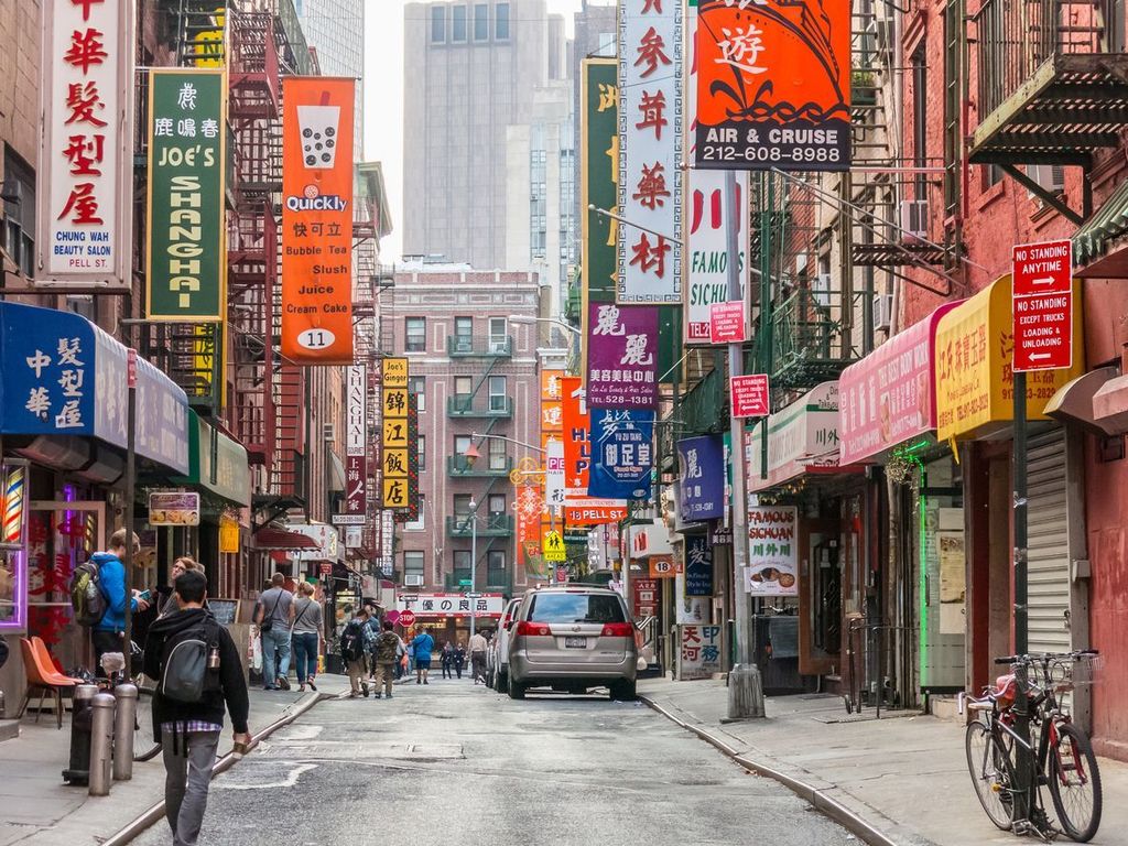 Tourists walks through Chinatown street, NYC