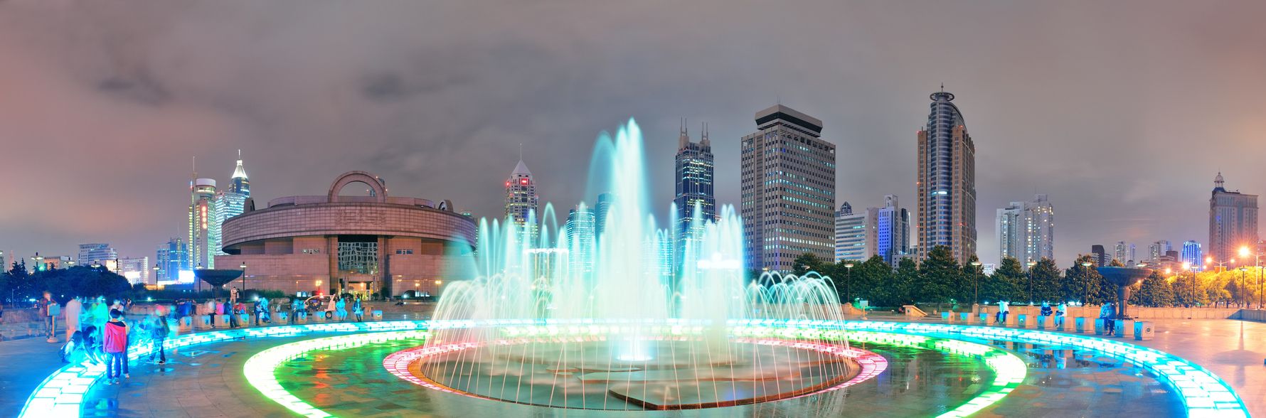 Shanghai People's Square with fountain and urban skyline at night panorama