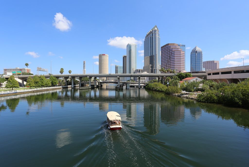 Downtown Tampa Bay with a boat cruising down the river
