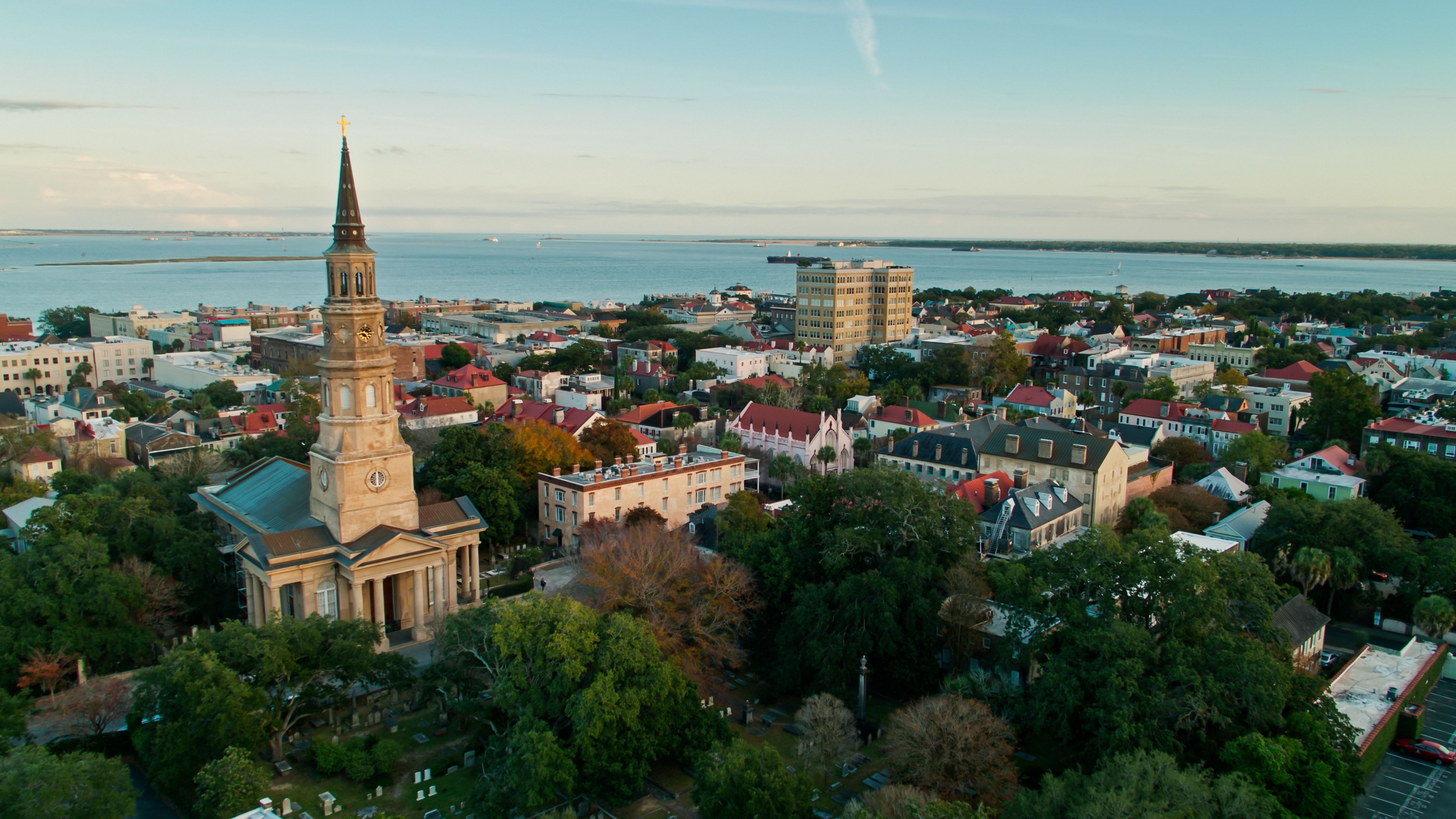 Charleston, South Carolina at sunset, looking past the spire of St Philip's Church towards the harbor
