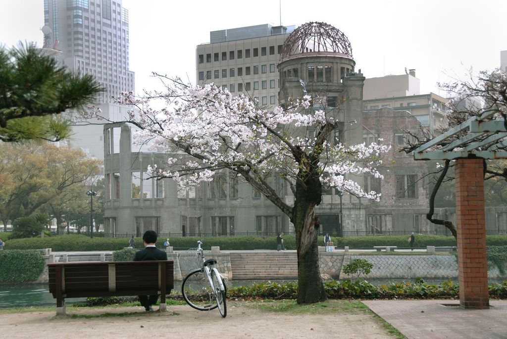 Hiroshima Decades After the Bomb, man sitting across from Genbaku Dome